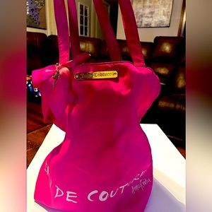 Juicy couture tote, pink. Black and white stripes inside.